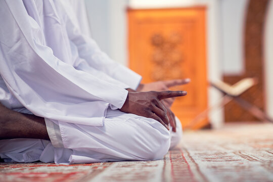 African Muslim Couple Praying inside of beutiful mosque