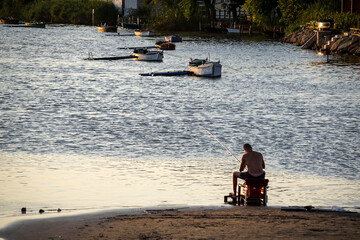 people fishing in the lagoon at sunset