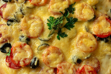 Pizza with Servelat salami or pepperoni, tomatoes, cheese and herbs as a food background or texture.