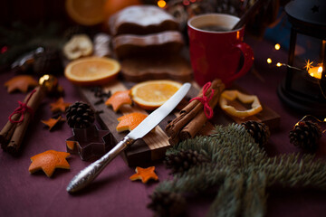 Christmas  and New Year preparations,serving table, hot coffee in the mug, christmas pie, fruits on the cutting board. holiday mood 