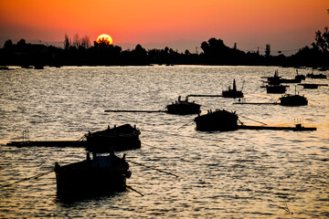 boats in the lagoon at sunset
