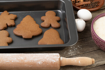 Traditional christmas gingerbread with ingredients over a wooden table
