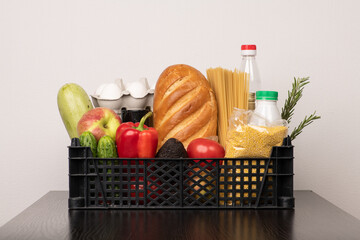 Mixed food basket with bread, vegetables, sauces, eggs and millet