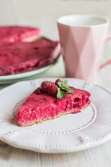 no baked berry pie, raspberry cheesecake, correct healthy dessert on a white plate, light background