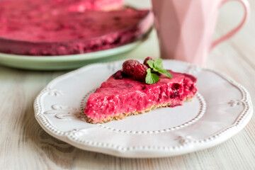 no baked berry pie, raspberry cheesecake, correct healthy dessert on a white plate, light background