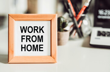 Work from home message on wden frame on office table