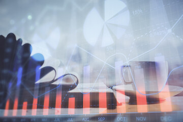 Double exposure of financial chart drawing and desktop with coffee and items on table background. Concept of forex market trading