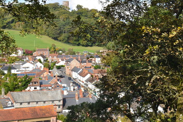 Obraz premium Dunster village set between foothills of Exmoor national park and the Somerset coast British treasure dominated by a castle It is probably the largest and most intact medieval establishment in England