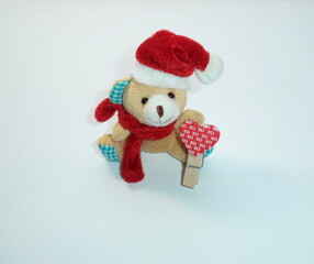Teddy bear toy in a Santa cap on a white background.