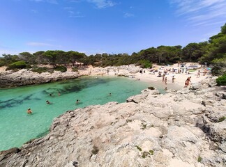Playa Cala Des Talaier famous paradise beach with turquoise water and pine forests on south coast of Menorca Island, Balearic Islands, Spain