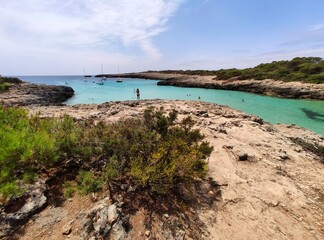 Playa Cala Des Talaier famous paradise beach with turquoise water and pine forests on south coast of Menorca Island, Balearic Islands, Spain