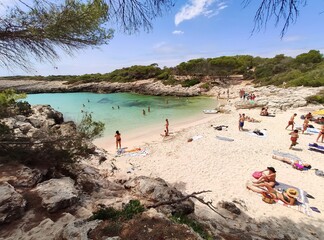 Playa Cala Des Talaier famous paradise beach with turquoise water and pine forests on south coast of Menorca Island, Balearic Islands, Spain