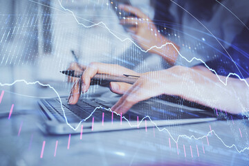 Multi exposure of woman hands typing on computer and financial graph hologram drawing. Stock market analysis concept.