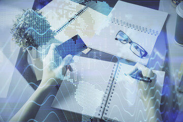 Multi exposure of woman on-line shopping holding a credit card and financial graph drawing. Stock market E-commerce concept.