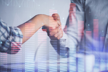 Double exposure of forex graph hologram and handshake of two men. Stock market concept.