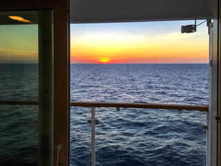 sunset from room on a cruise ship