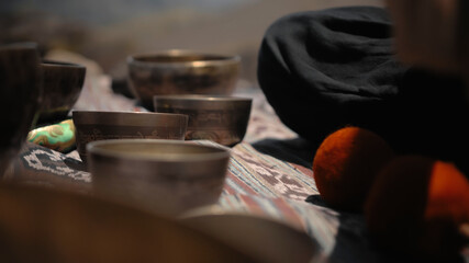 Asian guy playing Tibedt singing copper cups on a viewing mountain