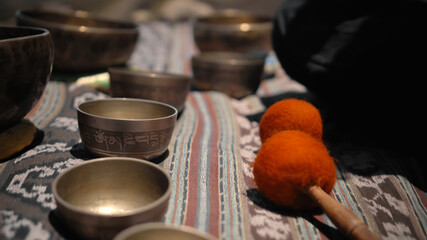 Asian guy playing Tibedt singing copper cups on a viewing mountain
