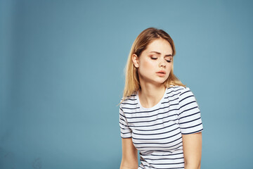 Obraz premium Emotional woman striped t-shirt lifestyle cropped blue background