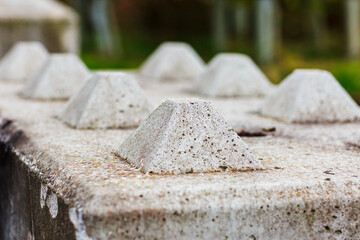 Close up of concrete block barriers showing the top locating pins.