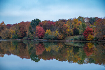 Trees in autumn colors reflect off Lake Casse in Carmel, N.Y.