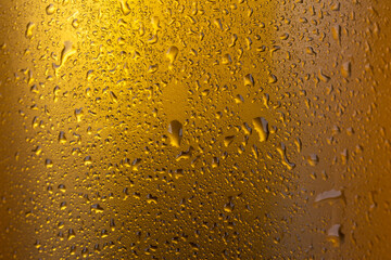 Closeup of cold lager beer background with water drops.