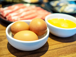Three egg yellow pork meal bacon on table sukiyaki shabu buffet cuisine japanese gourmet homemade resturant food and vegetable organic natural healthy  