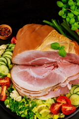Sliced ham with fresh salad close up.