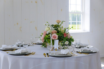 Elegance white table set in restaurant.