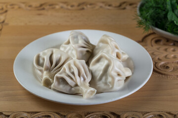 Georgian dumplings Khinkali with meat. Khinkali in a white plate.