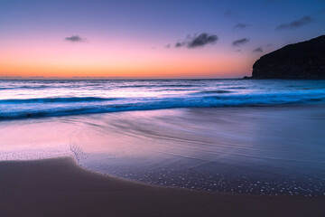 Fototapeta premium Hazy sunrise seascape with low swell
