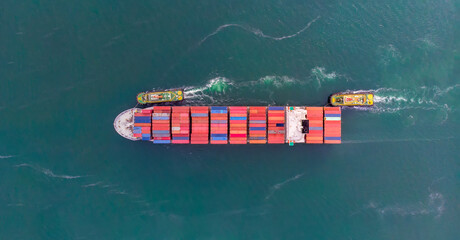Aerial top view of cargo ship carrying container and running for export  goods  from  cargo yard port to custom ocean concept freight shipping by ship .