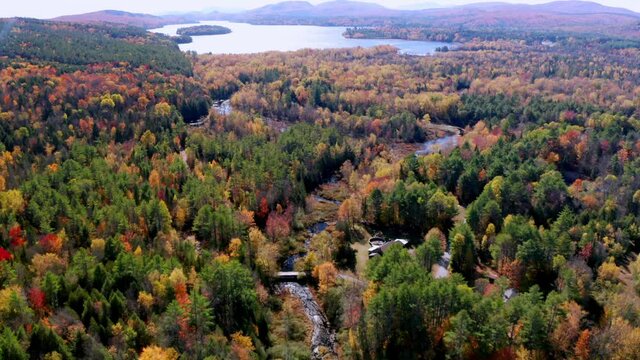 Aerial flythrough of Winding River Through Autumn Trees with Fall Colors in New England