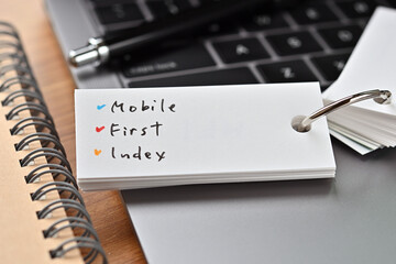 The words "MFI" written in a word book. Close-up.It is an acronym for "Mobile First Index".