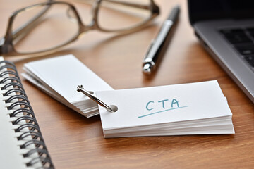 The words "CTA" written in a word book. Close-up. Close-up. It is an acronym for "Call To Action".
