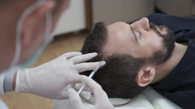 Hair mesotherapy or scalp prp: Platelet-rich plasma procedure. Beautician doctor makes injections in the man head for hair growth to prevent hair loss and baldness