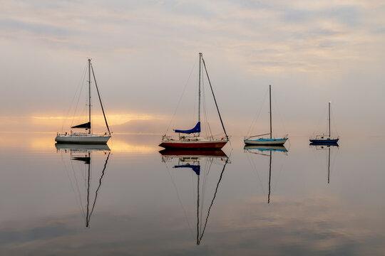 Misty Morning with Boats and Reflections on the Bay