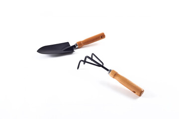 Tools garden shovel and rake isolated on white