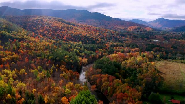 Aerial flythrough of Winding River Through Autumn Trees with Fall Colors in New England