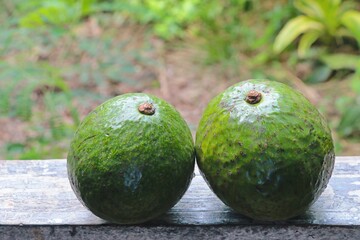 Avocados on a wooden floor