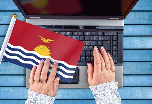 Woman Hands And Flag Of Kiribati On Computer, Laptop Keyboard 