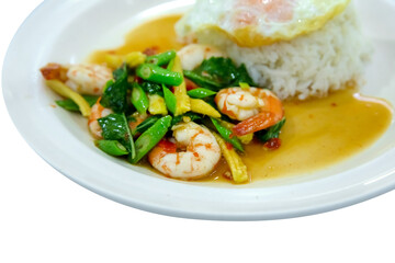 Stirred fry shrimps or prawns with basil leaves, fried egg over rice on white isolated.