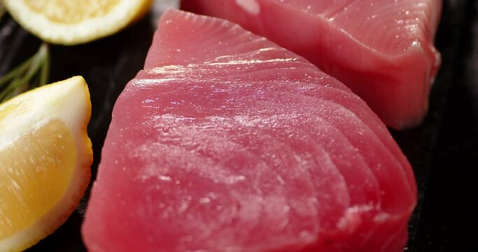 Raw tuna steak on a stone board. 