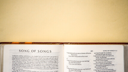 Open pages of the bible background (book of song of songs)