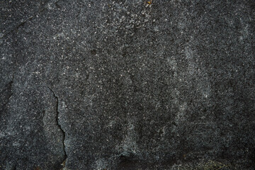 Dark gray stone texture. Industrial design background. Abstract grunge. Old rough black granite surface. Image with copy space.