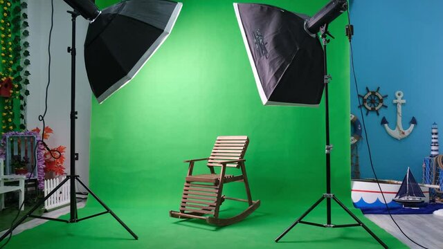 Photo or video studio with two hexagone studio lights. Green screen and rocking chair