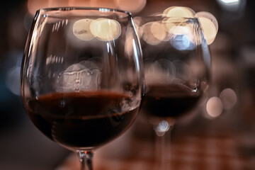 abstract aperitif alcohol glass in a restaurant interior, red wine background