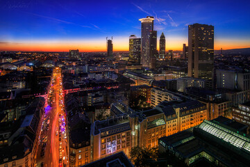 Naklejka na ściany i meble Frankfurt skyline in Germany photographed from above and at night with great lights and the illuminated skyscrapers