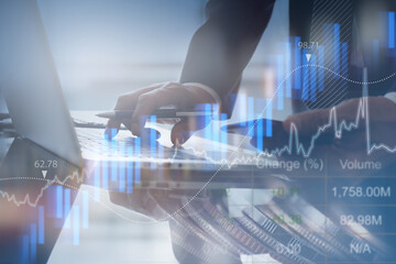 Businessman monitoring stock market report and analyzing financial graph for business finance and...