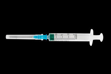 Empty syringe close up isolated on black background. Vaccine plastic hypodermic syringe. Close-up of medical syringe. Syringe for injection and vaccination solution.